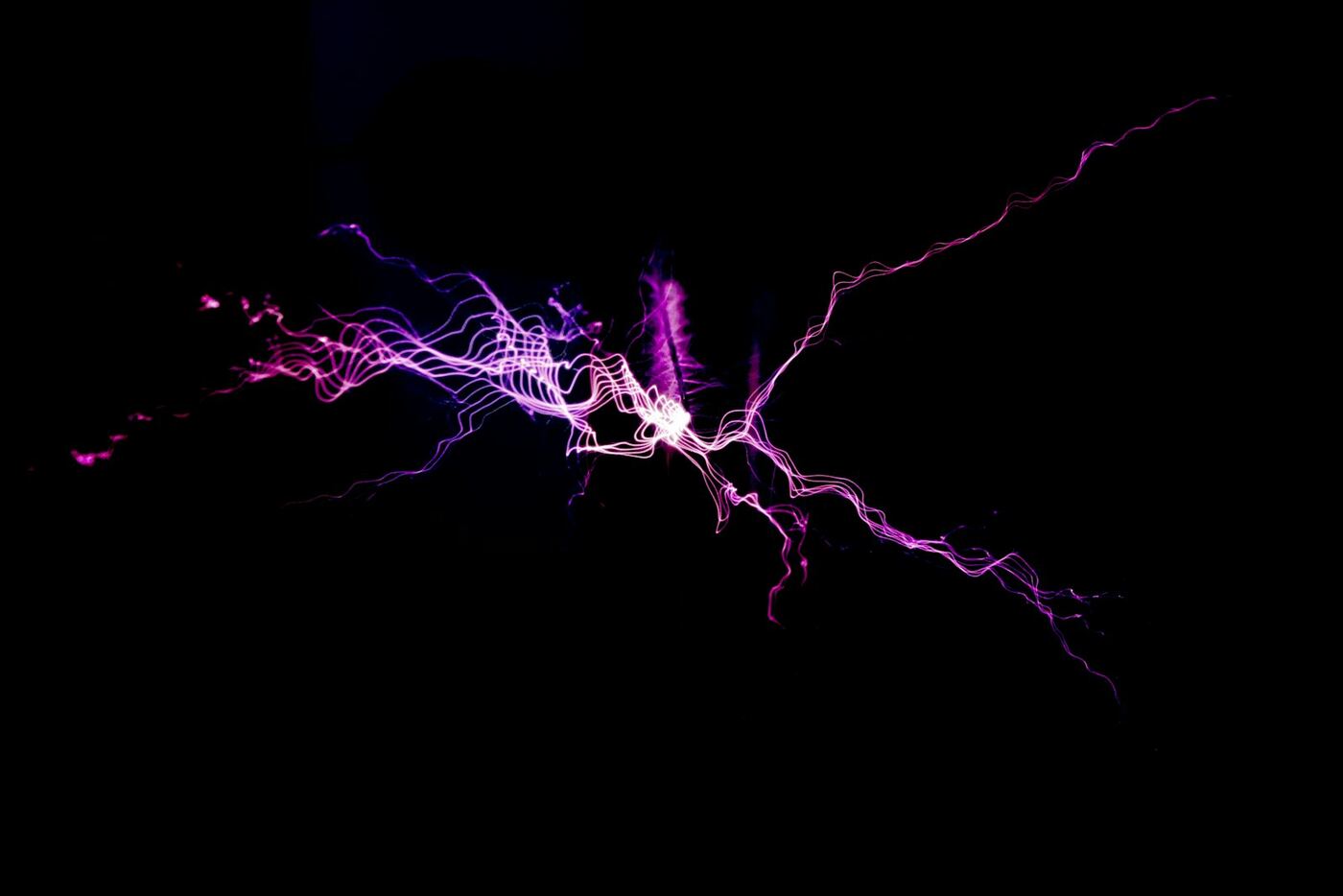 Karanlık zeminde mor bir elektrik boşalması